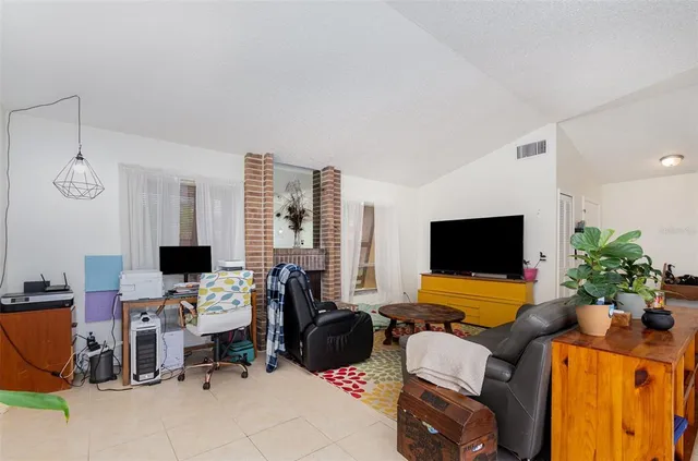 a view of a livingroom with workspace and a couch