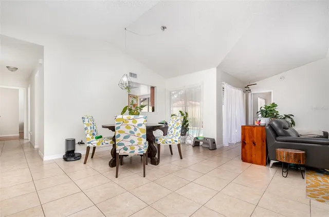 a living room with furniture and a dining table