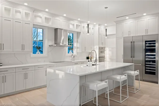 a kitchen with stainless steel appliances kitchen island granite countertop a sink and cabinets