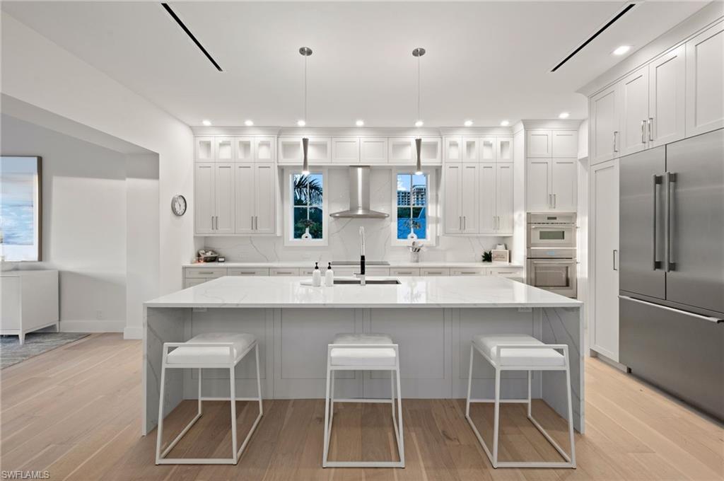 1984 Frederick Street Naples, FL 34112 - Photo 13 of 38 a kitchen with a sink and chairs