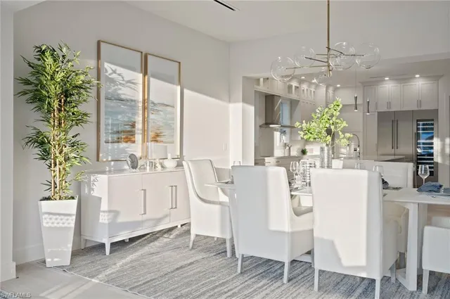 a dining room with furniture potted plants and wooden floor
