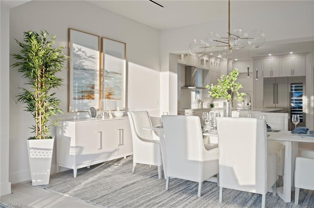 1984 Frederick Street Naples, FL 34112 - Photo 14 of 38 a dining room with furniture potted plants and wooden floor
