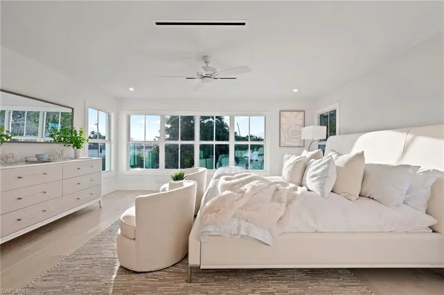 a spacious bedroom with a bed and a window