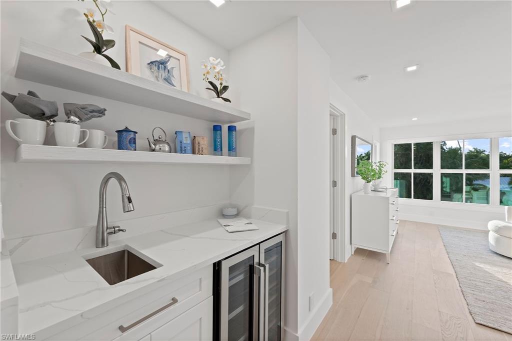 1984 Frederick Street Naples, FL 34112 - Photo 18 of 38 a kitchen with a sink a refrigerator and a window