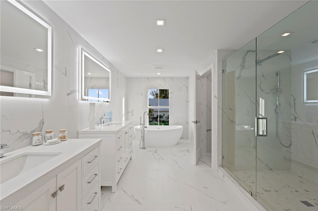 1984 Frederick Street Naples, FL 34112 - Photo 19 of 38 a spacious bathroom with a shower sink double vanity and bathtub