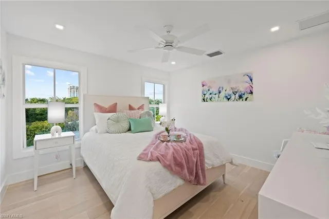 a bedroom with a bed and a painting on the wall