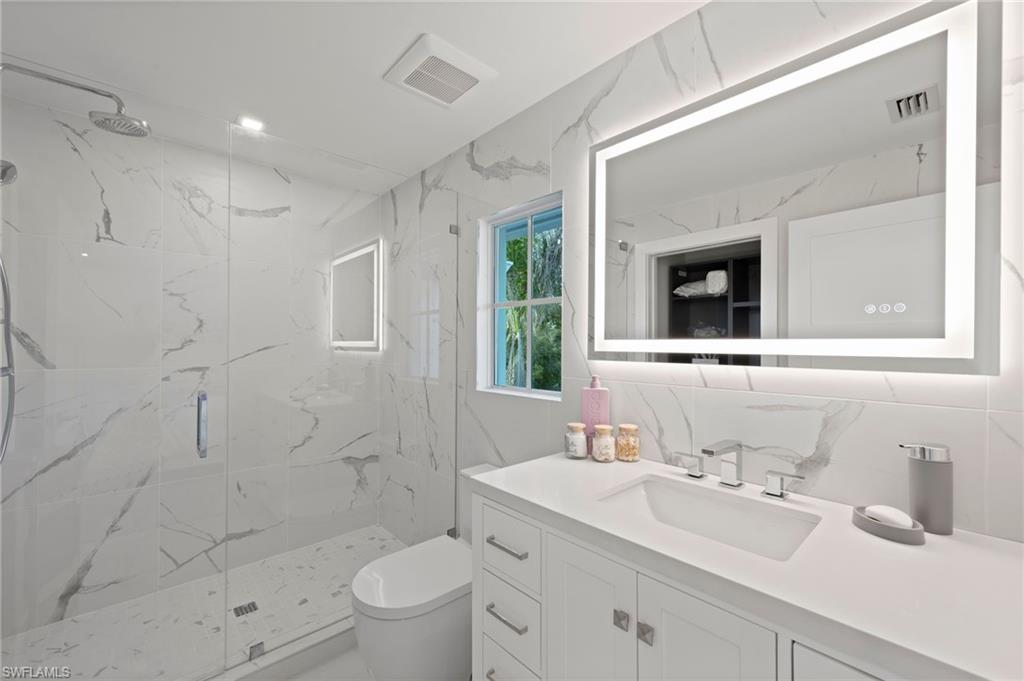 1984 Frederick Street Naples, FL 34112 - Photo 23 of 38 a bathroom with a sink a toilet and shower
