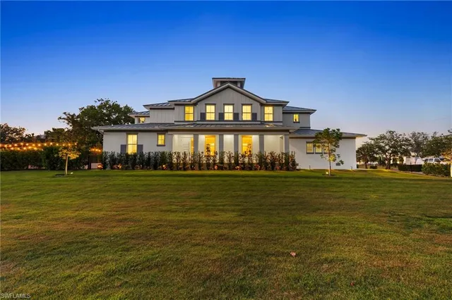 a front view of a building with a garden