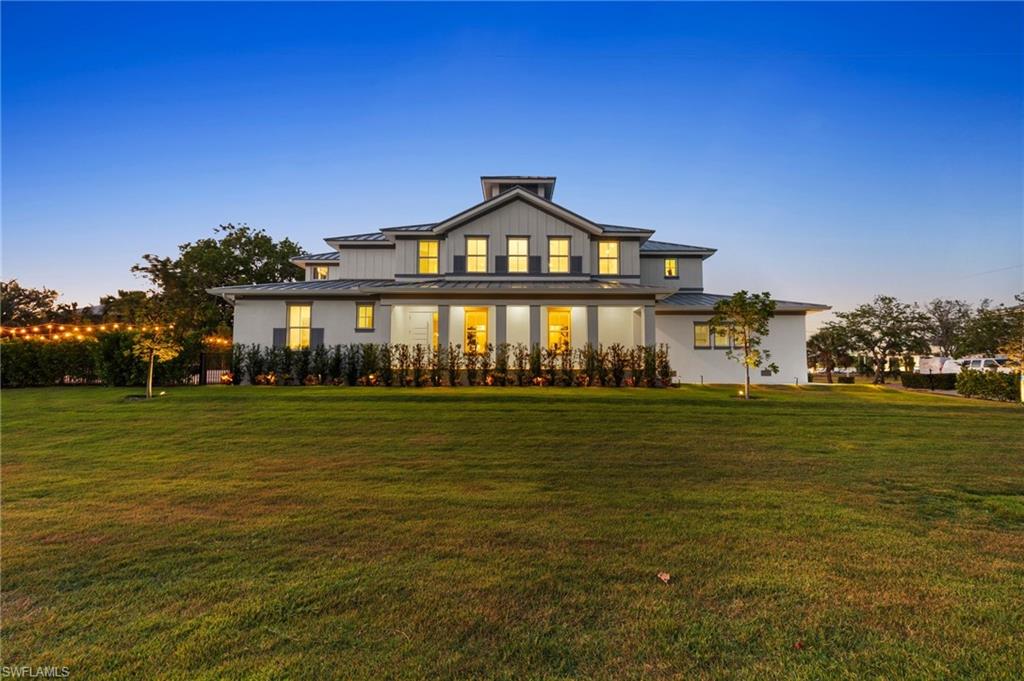 1984 Frederick Street Naples, FL 34112 - Photo 3 of 38 a front view of a building with a garden