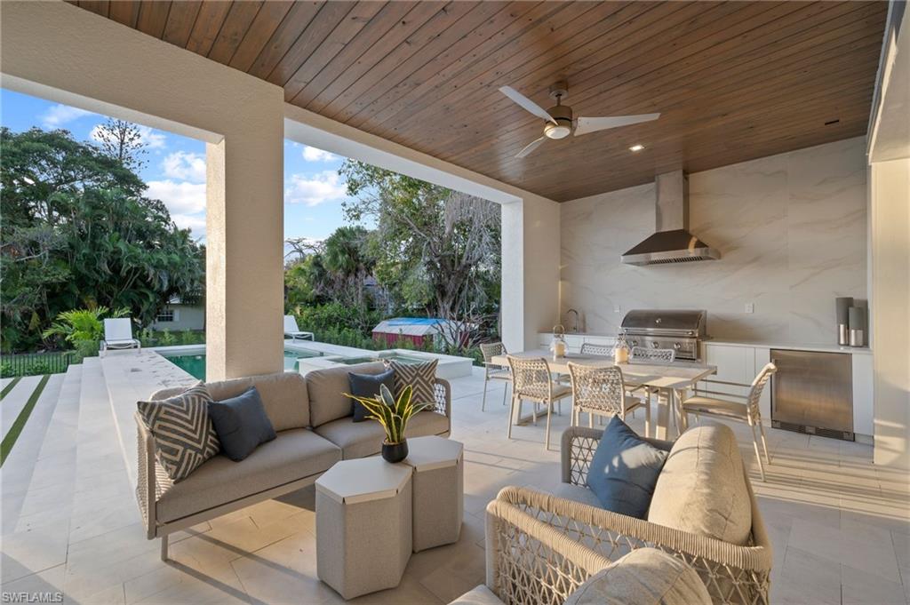 1984 Frederick Street Naples, FL 34112 - Photo 31 of 38 a living room with furniture and a large window