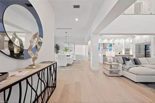 a living room with furniture and a mirror