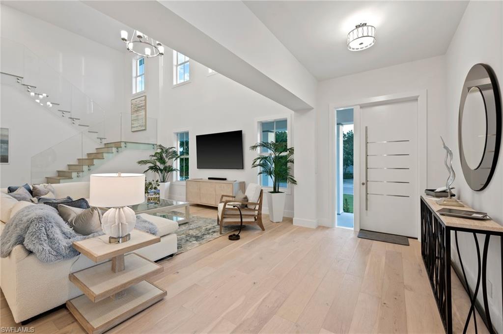 1984 Frederick Street Naples, FL 34112 - Photo 7 of 38 a living room with furniture a flat screen tv and a large window
