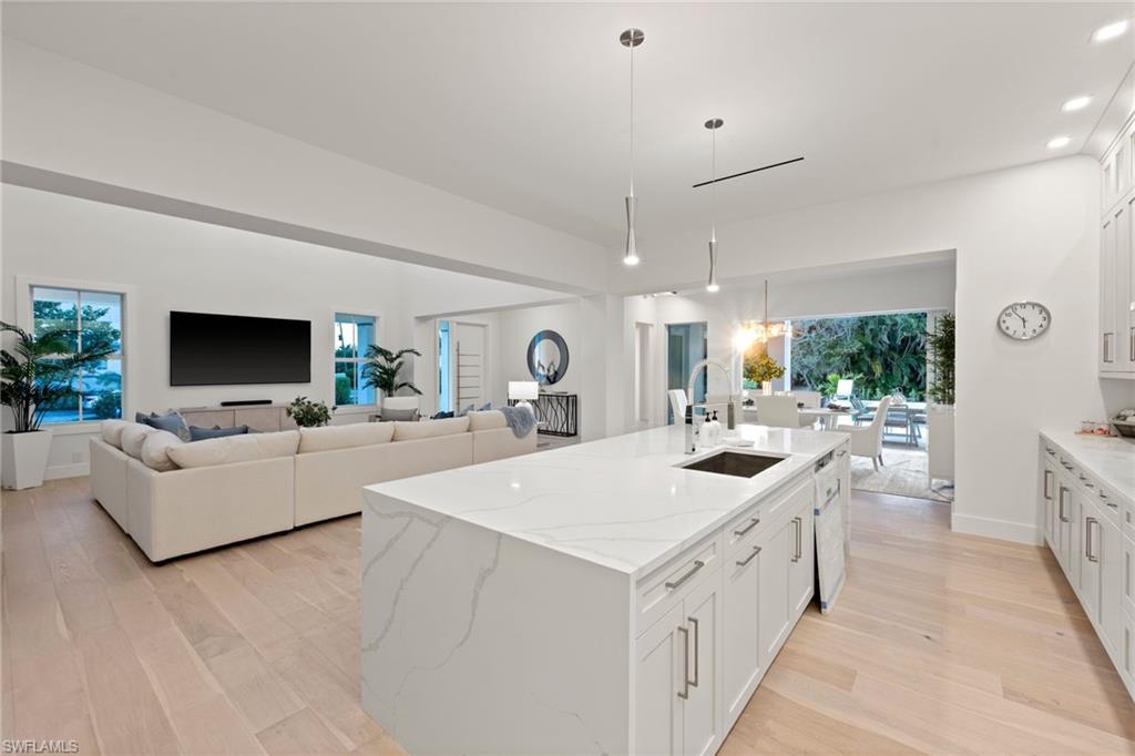 1984 Frederick Street Naples, FL 34112 - Photo 10 of 38 a large white kitchen with a sink and a stove top oven
