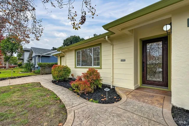 an empty room with wooden floor and natural light