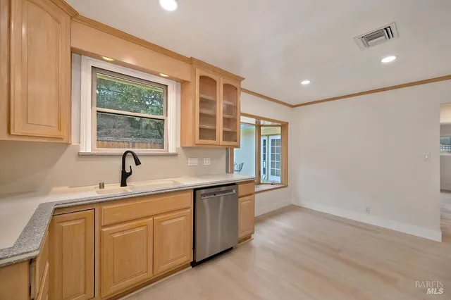 a kitchen with stainless steel appliances kitchen island granite countertop a stove a sink and a microwave