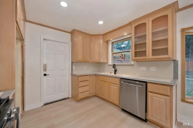 an empty room with windows and closet