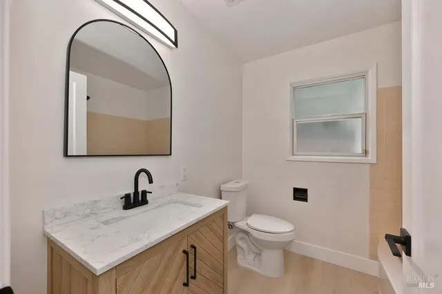 a bathroom with a toilet sink and mirror