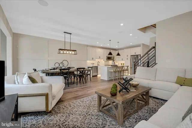 a living room with furniture and view of kitchen
