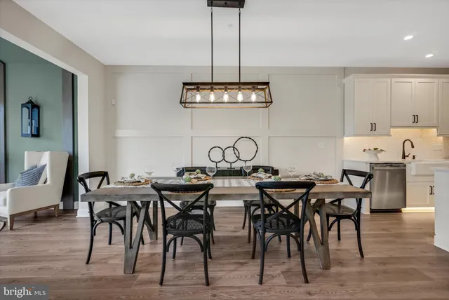 a view of a dining room with furniture and chandelier