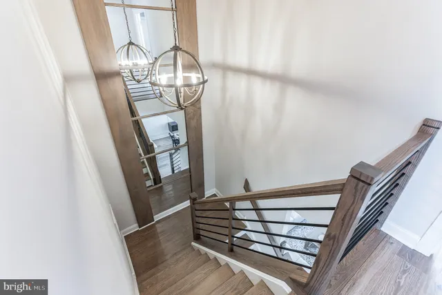 a view of staircase with white walls and railing