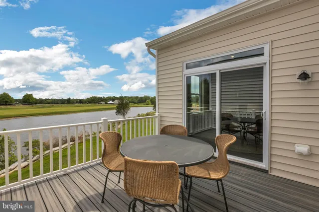a view of a chair and table on the wooden deck