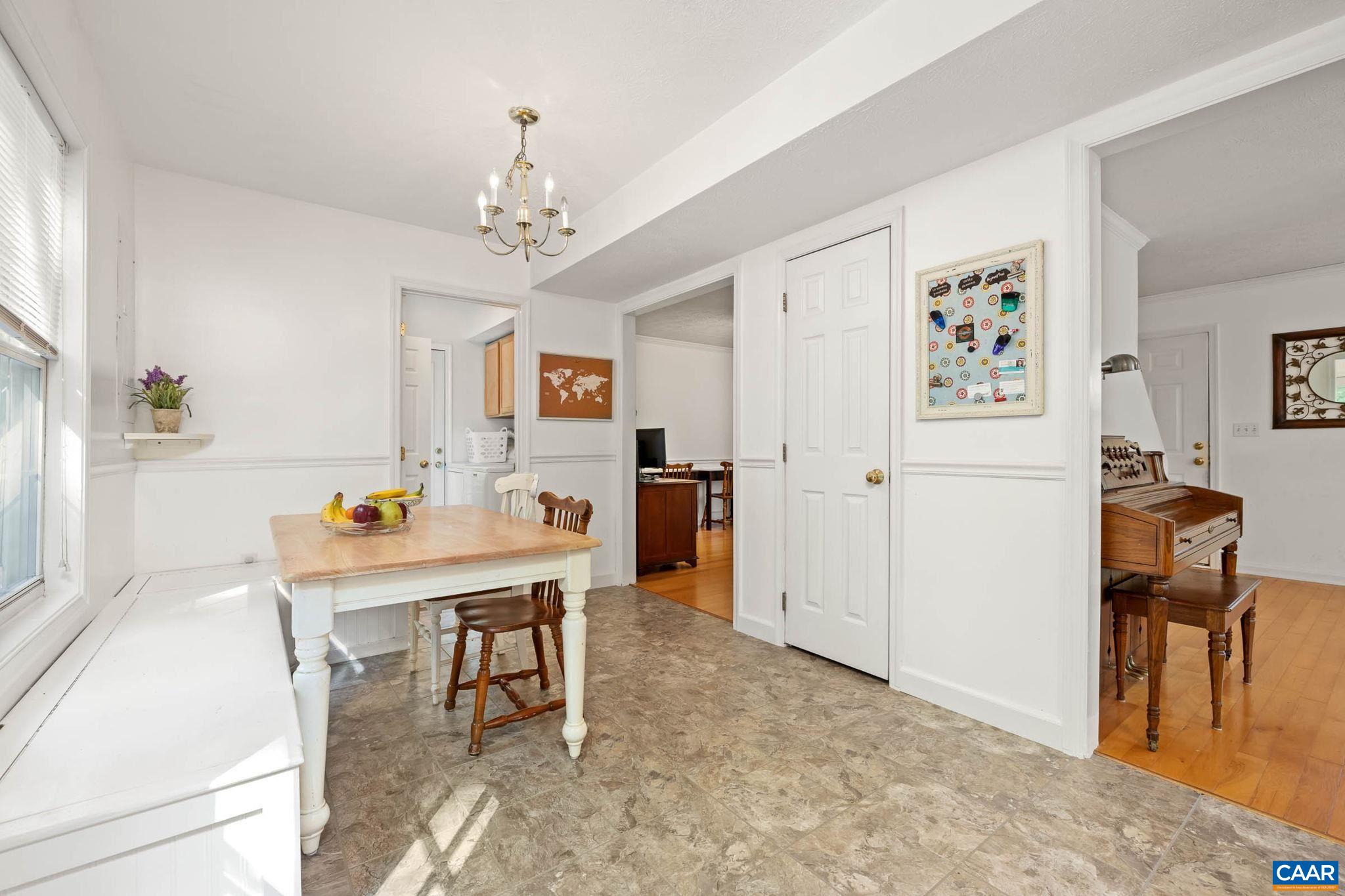 326 Geranium Road Ruckersville, VA 22968 - Photo 23 of 48 a view of a dining room with furniture and a chandelier