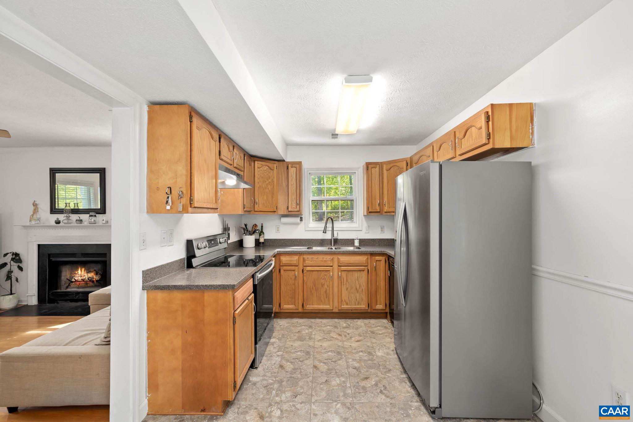 326 Geranium Road Ruckersville, VA 22968 - Photo 24 of 48 a kitchen with stainless steel appliances granite countertop a refrigerator a stove a sink and a microwave