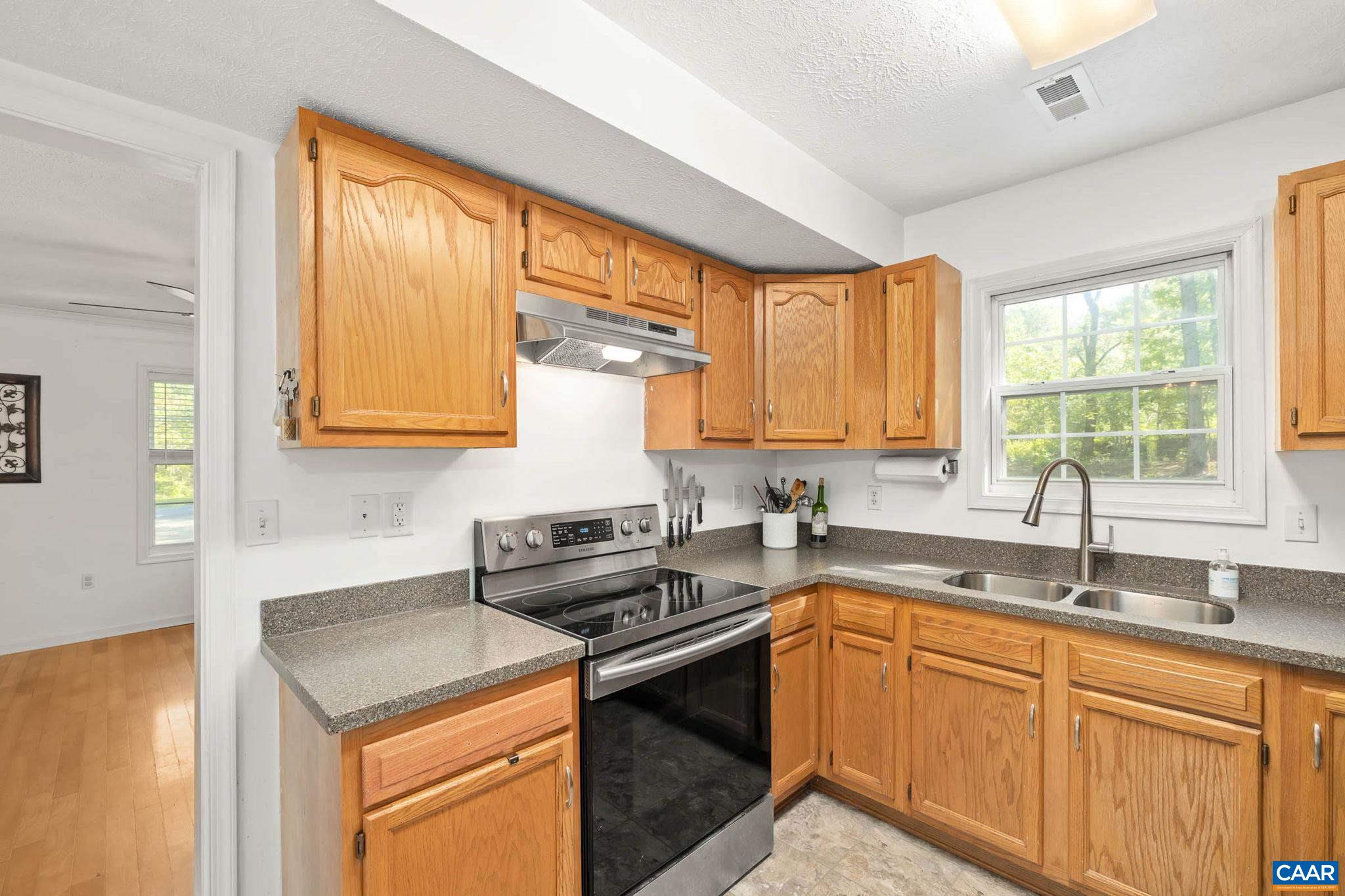 326 Geranium Road Ruckersville, VA 22968 - Photo 26 of 48 a kitchen with a sink stove top oven and cabinets