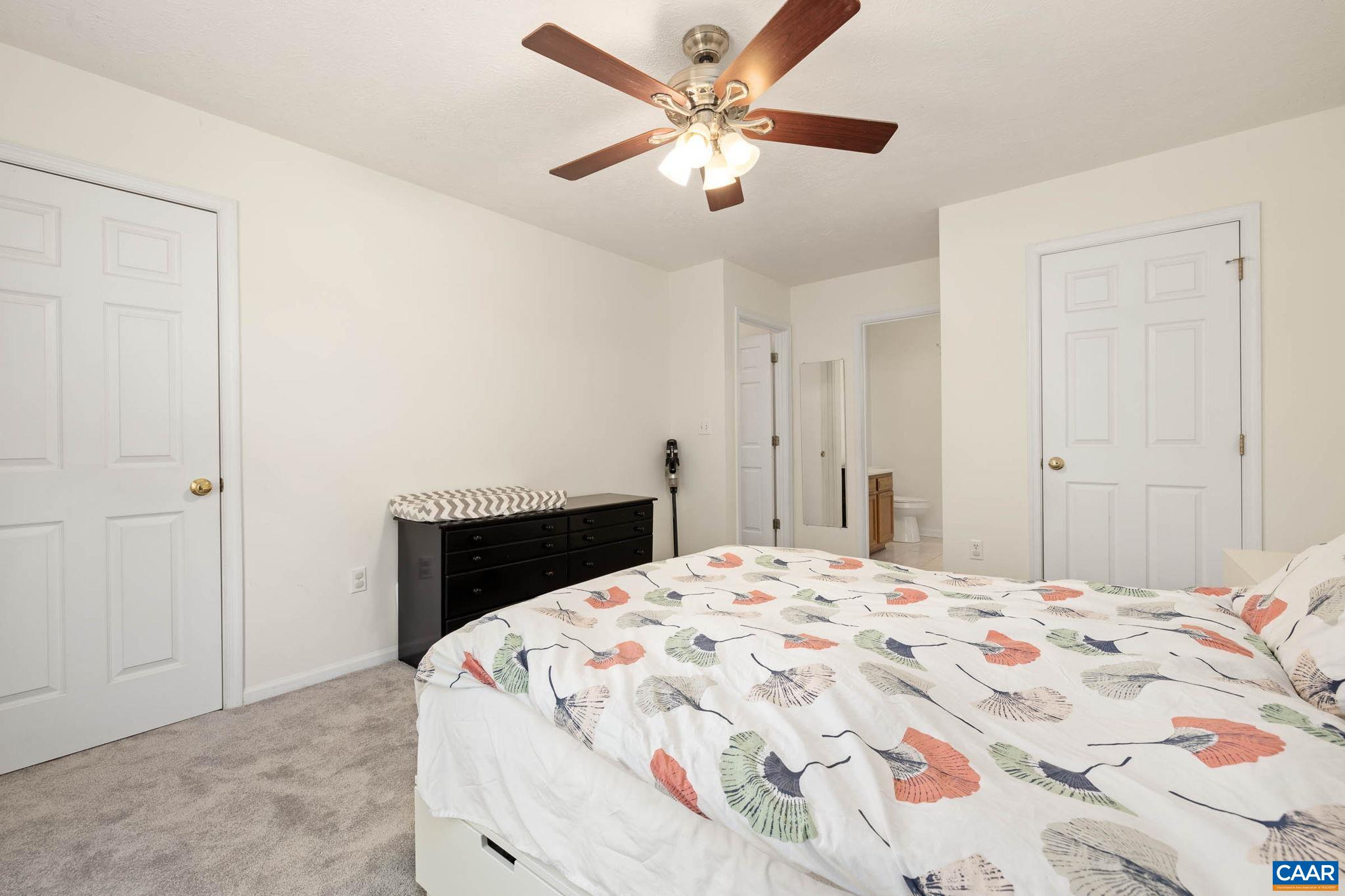 326 Geranium Road Ruckersville, VA 22968 - Photo 35 of 48 a bedroom with a bed and a chandelier