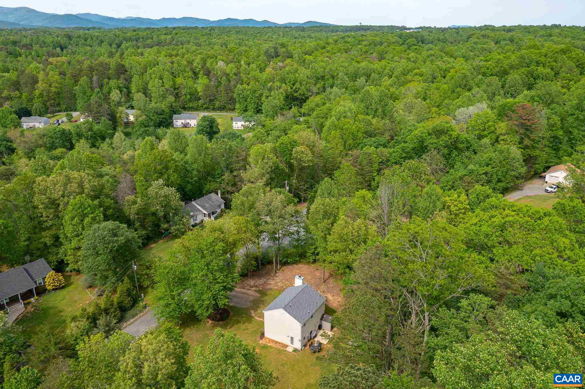 326 Geranium Road Ruckersville, VA 22968 - Photo 45 of 48 a view of a lush green forest with trees and some houses