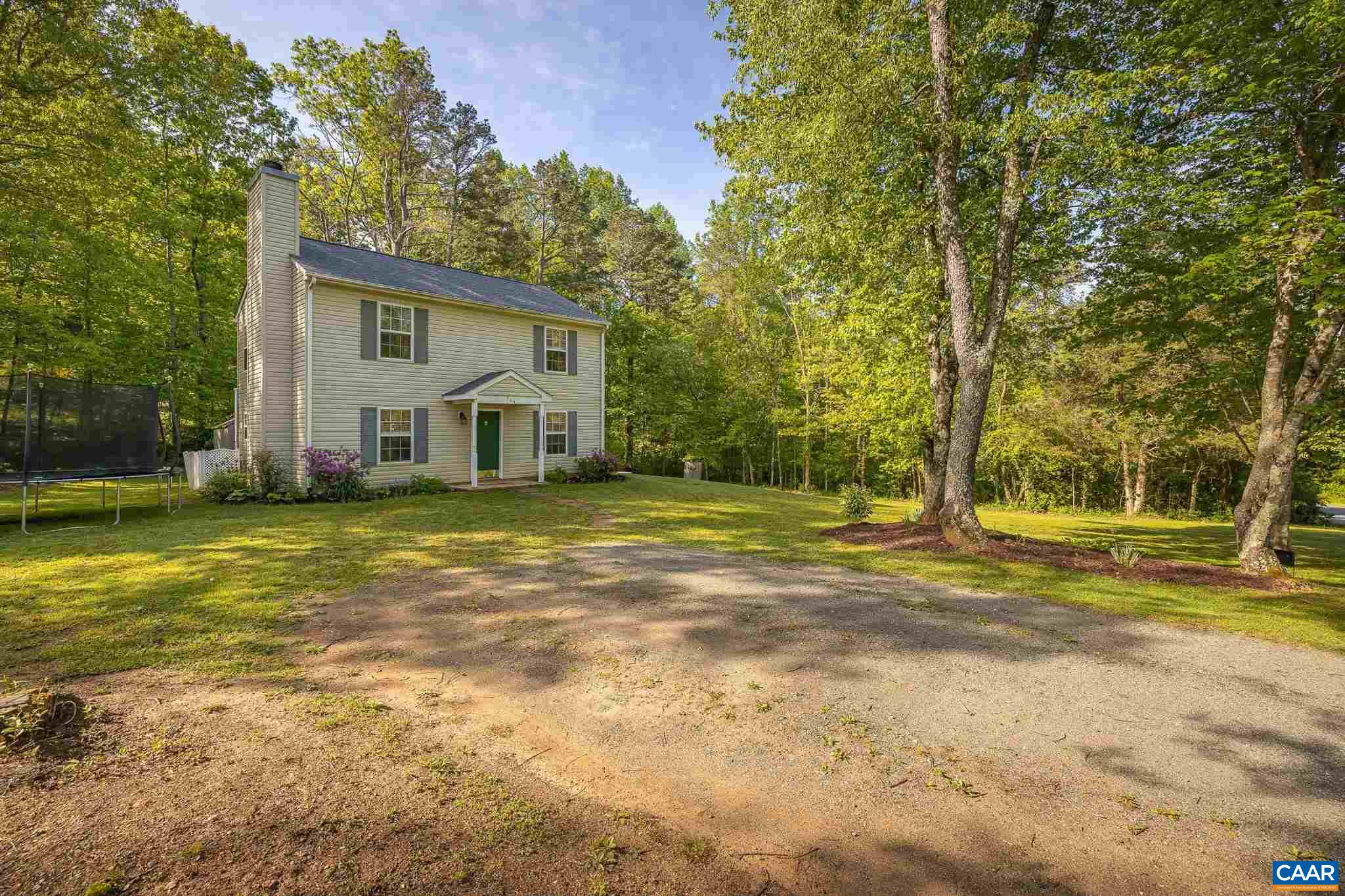 326 Geranium Road Ruckersville, VA 22968 - Photo 6 of 48 a view of a house with a big yard and large trees