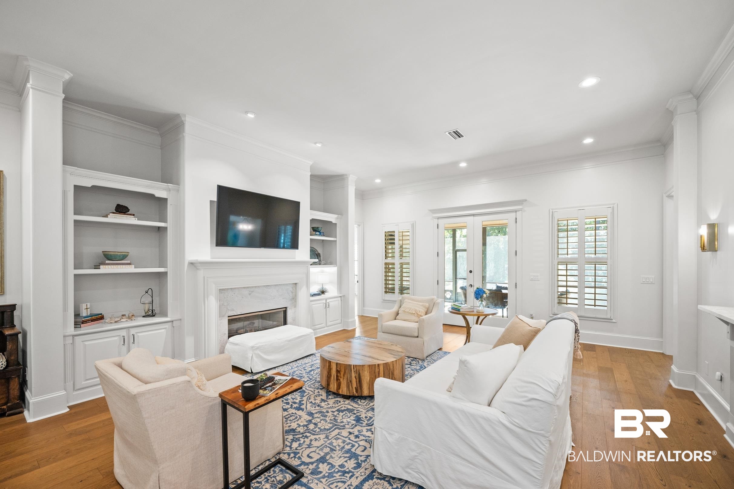 115 Sandy Ford Road Fairhope, AL 36532 - Photo 9 of 47 Living area featuring a fireplace, hardwood / wood-style flooring, recessed lighting, crown molding, and french doors
