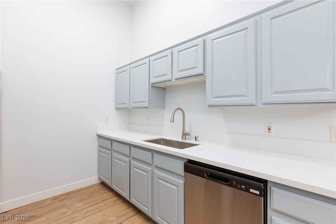 2305 West Horizon Ridge Parkway, Unit 1822 Henderson, NV 89052 - Photo 12 of 34 Kitchen with dishwasher, light wood finished floors, light stone counters, and gray cabinetry