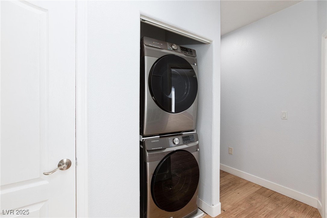 2305 West Horizon Ridge Parkway, Unit 1822 Henderson, NV 89052 - Photo 23 of 34 Laundry area featuring light wood finished floors and stacked washer and clothes dryer