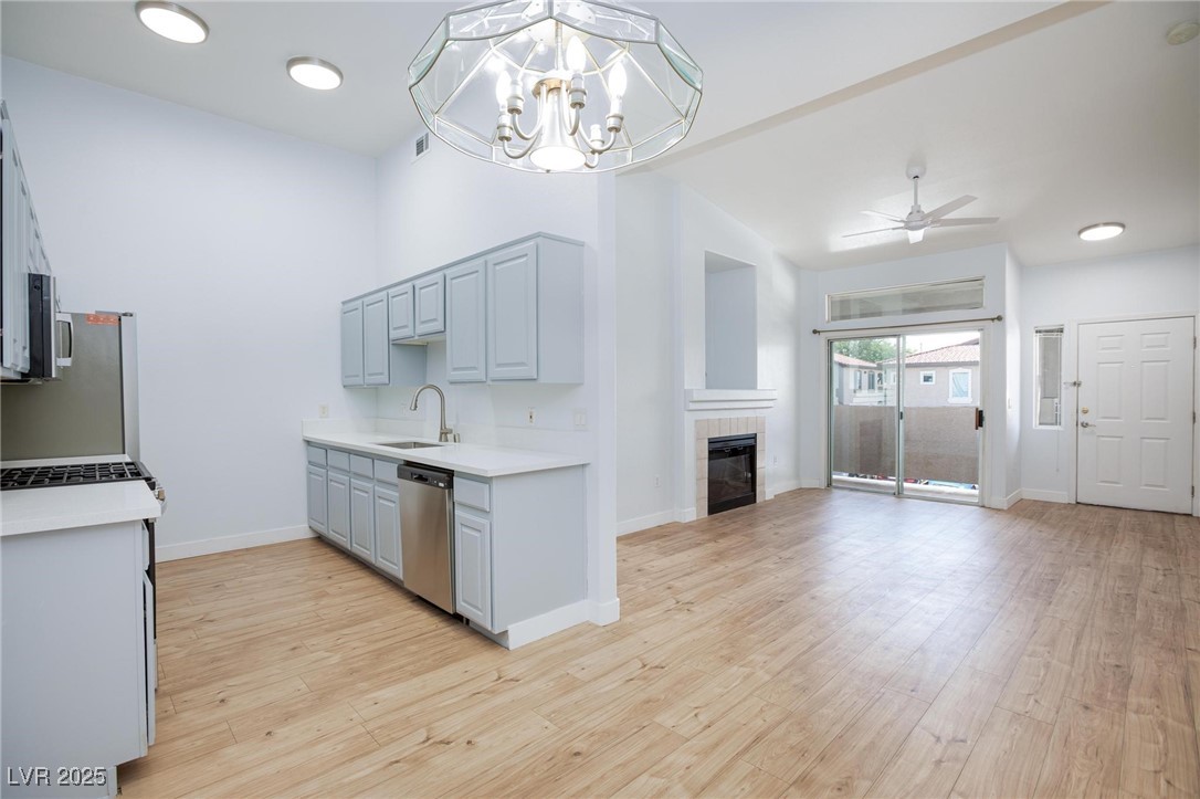 2305 West Horizon Ridge Parkway, Unit 1822 Henderson, NV 89052 - Photo 10 of 34 Kitchen with light wood-style floors, ceiling fan, appliances with stainless steel finishes, a fireplace, and recessed lighting