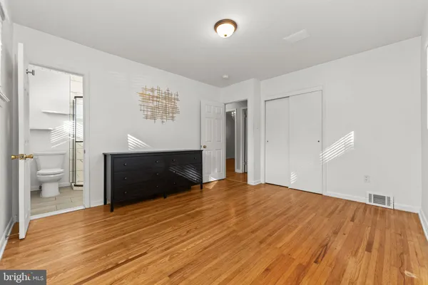 a view of empty room with wooden floor and fireplace