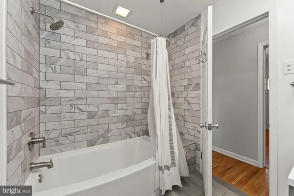 a bathroom with a bathtub and a shower