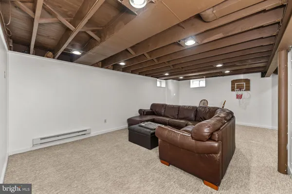 a media room with furniture and a ceiling fan