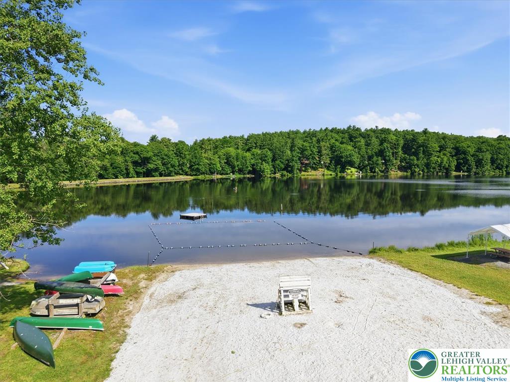 128 Chestnut Street Dingmans Ferry, PA 18328 - Photo 36 of 43 Lakefront sand beach with ample space for water activities and relaxation.