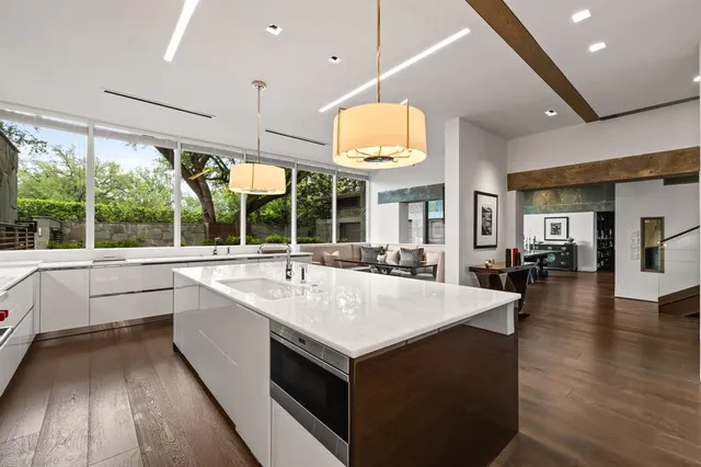 a large white kitchen with a large window