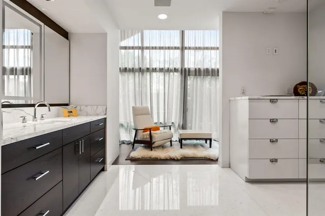 a spacious bathroom with a double vanity sink and mirror