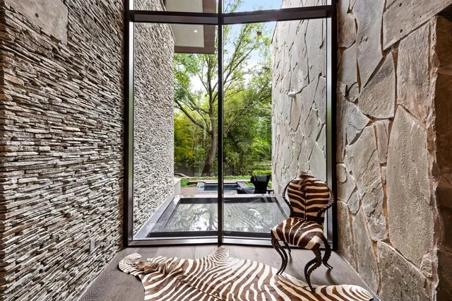 a view of a room with chairs and wooden floor