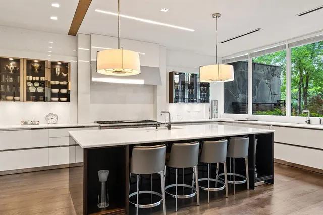 a kitchen with a sink and chairs