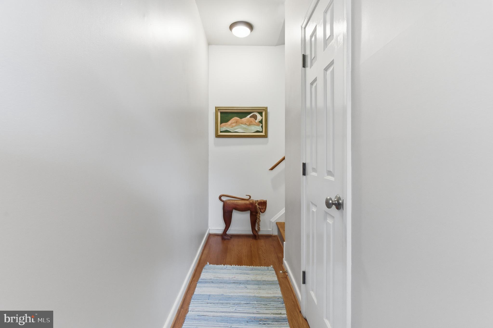 122 West Henrietta Street, Unit 5 Baltimore, MD 21230 - Photo 28 of 31 a view of a hallway with wooden floor and a staircase