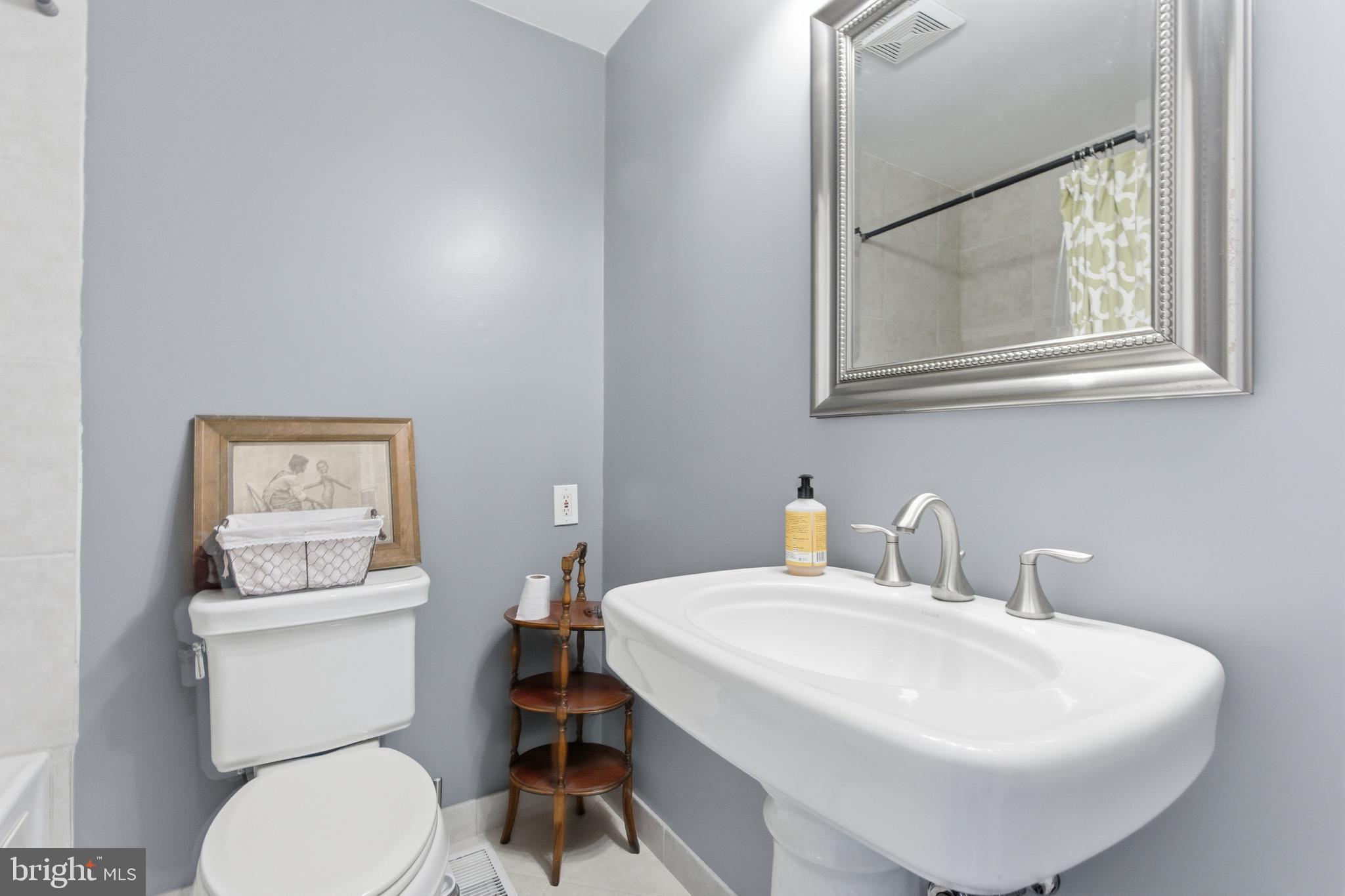 122 West Henrietta Street, Unit 5 Baltimore, MD 21230 - Photo 10 of 31 a bathroom with a sink toilet and mirror