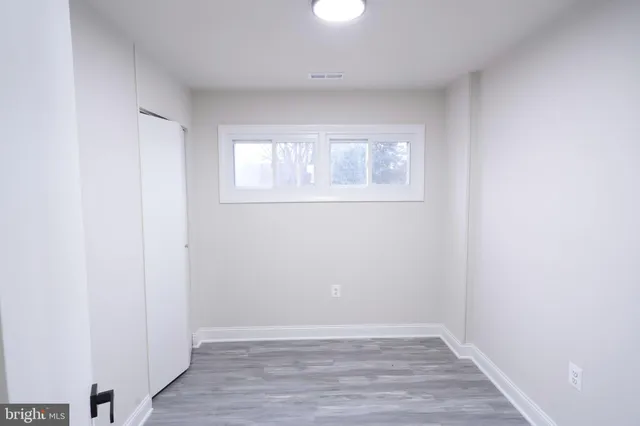 a bathroom with a granite countertop sink a mirror and bathtub
