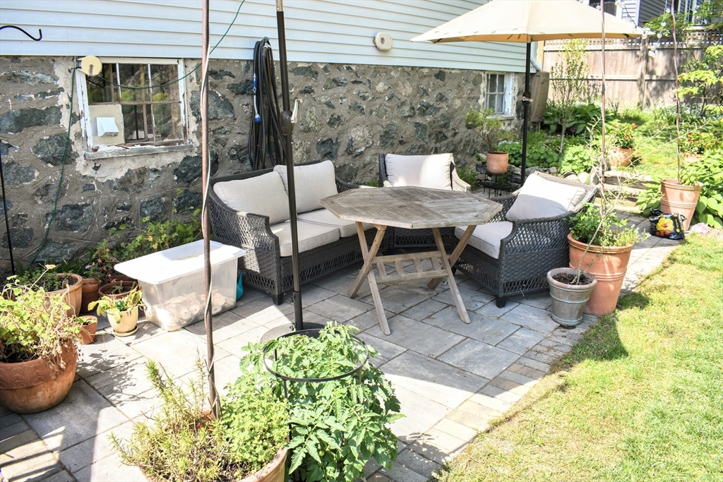 12 Searle Road, Unit 12 Boston, MA 02132 - Photo 8 of 35 a view of a patio with table and chairs potted plants