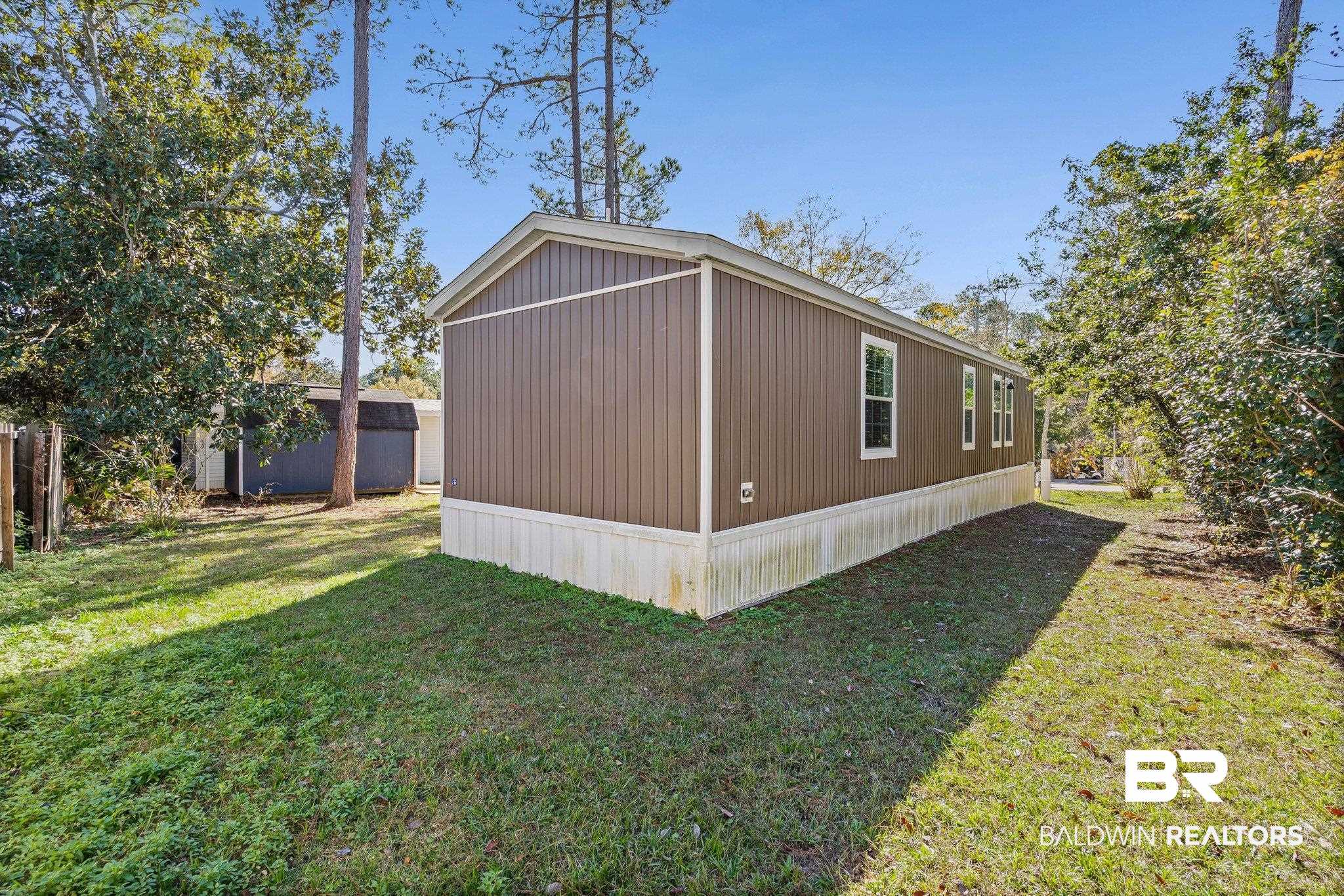 1325 Ridgewood Drive Lillian, AL 36549 - Photo 19 of 32 View of side of property featuring a lawn