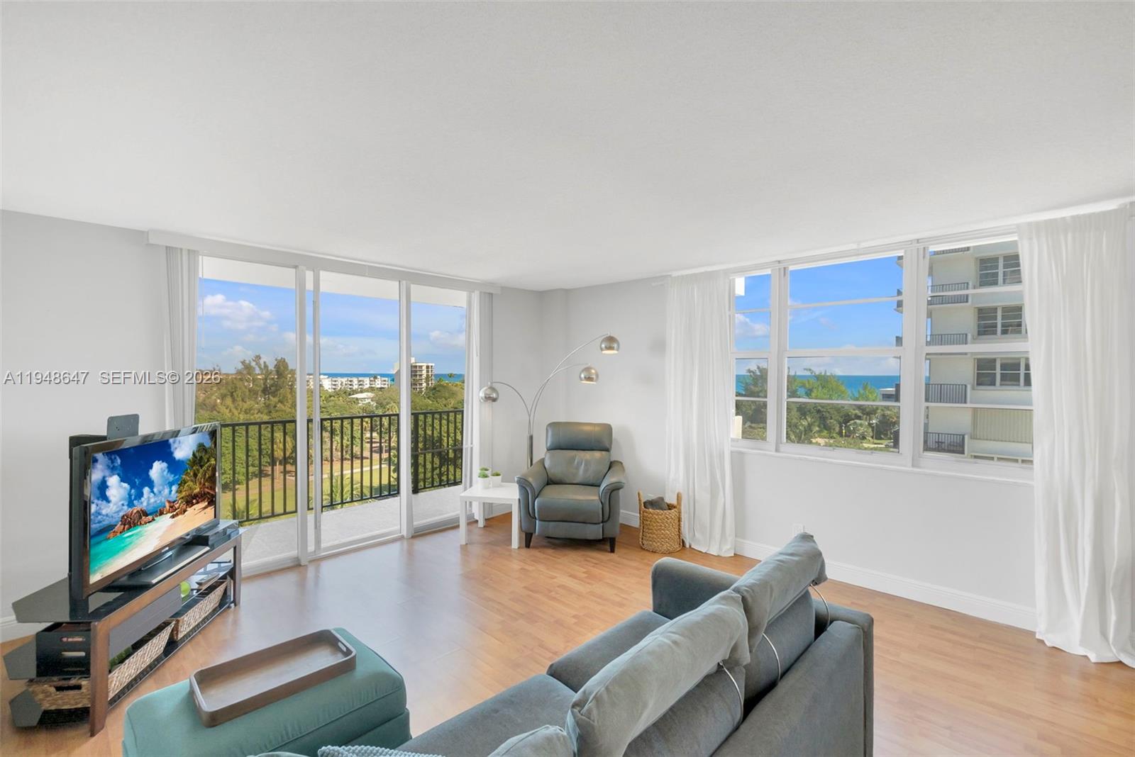 2121 North Ocean Boulevard, Unit 902W Boca Raton, FL 33431 - Photo 12 of 62 a living room with furniture tv and a flat screen tv