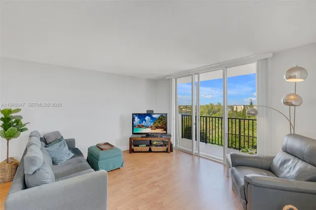 a living room with furniture and a floor to ceiling window